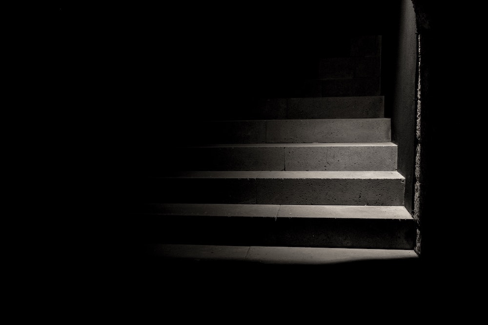 A dark staircase (Unsplash/Carolina Pimenta) A dark staircase (Unsplash/Carolina Pimenta)