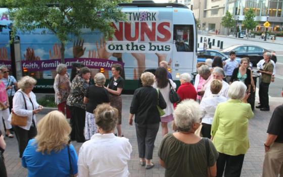 Women religious and their supporters gather in Charlotte, N.C., to greet the Nuns on the Bus in this 2013 photo. The campaign by NETWORD, a Catholic social justice lobby group, began in 2012 to garner political support for solutions to poverty and income inequality and for immigration reform. (CNS/Patricia L. Guilfoyle, Catholic News Herald)