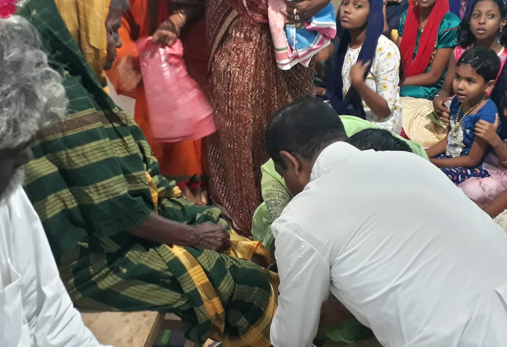 Fr. Anthony Packiam, parish priest of Christ the King church in Madurai in the southern Indian state of Tamil Nadu, washes a woman's feet on Holy Thursday 2022. (Courtesy of Sujata Jena) Fr. Anthony Packiam, parish priest of Christ the King church in Madurai in the southern Indian state of Tamil Nadu, washes a woman's feet on Holy Thursday 2022. (Courtesy of Sujata Jena)