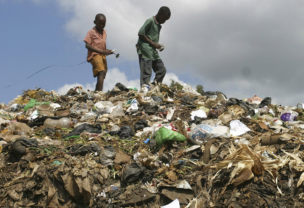 Children from a slum area scavenge through a garbage dump in Nairobi, Kenya, in late February 2009. (CNS/Reuters/Noor Khamis) Children from a slum area scavenge through a garbage dump in Nairobi, Kenya, in late February 2009. (CNS/Reuters/Noor Khamis)