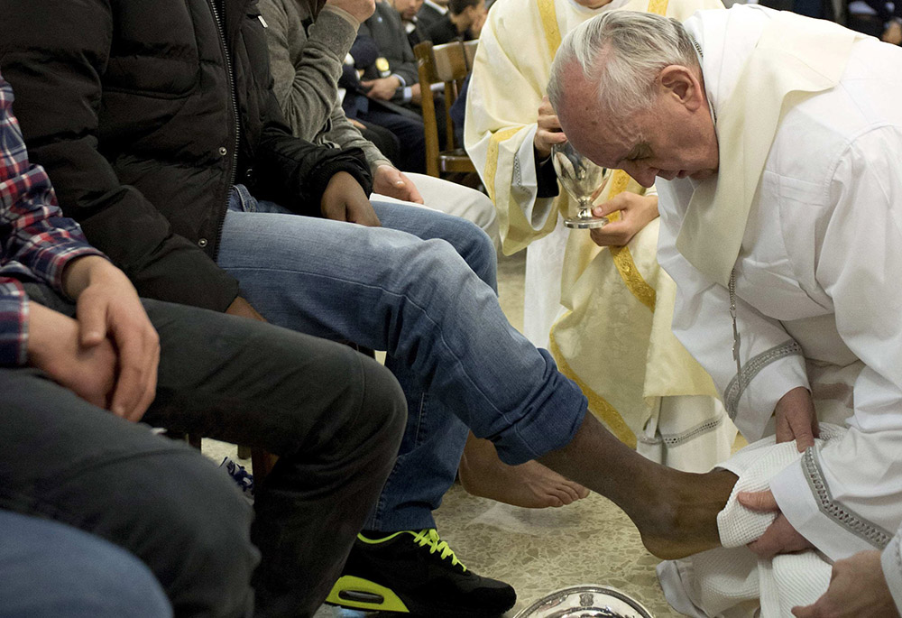 Pope Francis washes the foot of a prison inmate during the Holy Thursday Mass of the Lord's Supper at Rome's Casal del Marmo prison for minors March 28, 2013. (CNS/Reuters/L'Osservatore Romano) Pope Francis washes the foot of a prison inmate during the Holy Thursday Mass of the Lord's Supper at Rome's Casal del Marmo prison for minors March 28, 2013. (CNS/Reuters/L'Osservatore Romano)