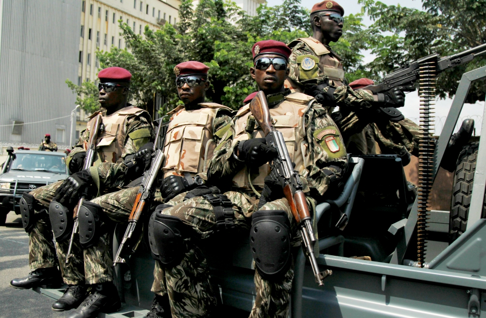 Members of the Ivory Coast presidential guard patrol as they arrive at the port of Abidjan. (CNS/Reuters/Luc Gnago) Members of the Ivory Coast presidential guard patrol as they arrive at the port of Abidjan. (CNS/Reuters/Luc Gnago)