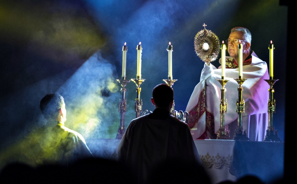 Capuchin Franciscan Fr. John Lager, national chaplain for FOCUS since 2013, holds the monstrance during adoration at the organization's SEEK 2015 gathering in Nashville, Tennessee. (CNS/Courtesy of FOCUS) Capuchin Franciscan Fr. John Lager, national chaplain for FOCUS since 2013, holds the monstrance during adoration at the organization's SEEK 2015 gathering in Nashville, Tennessee. (CNS/Courtesy of FOCUS)