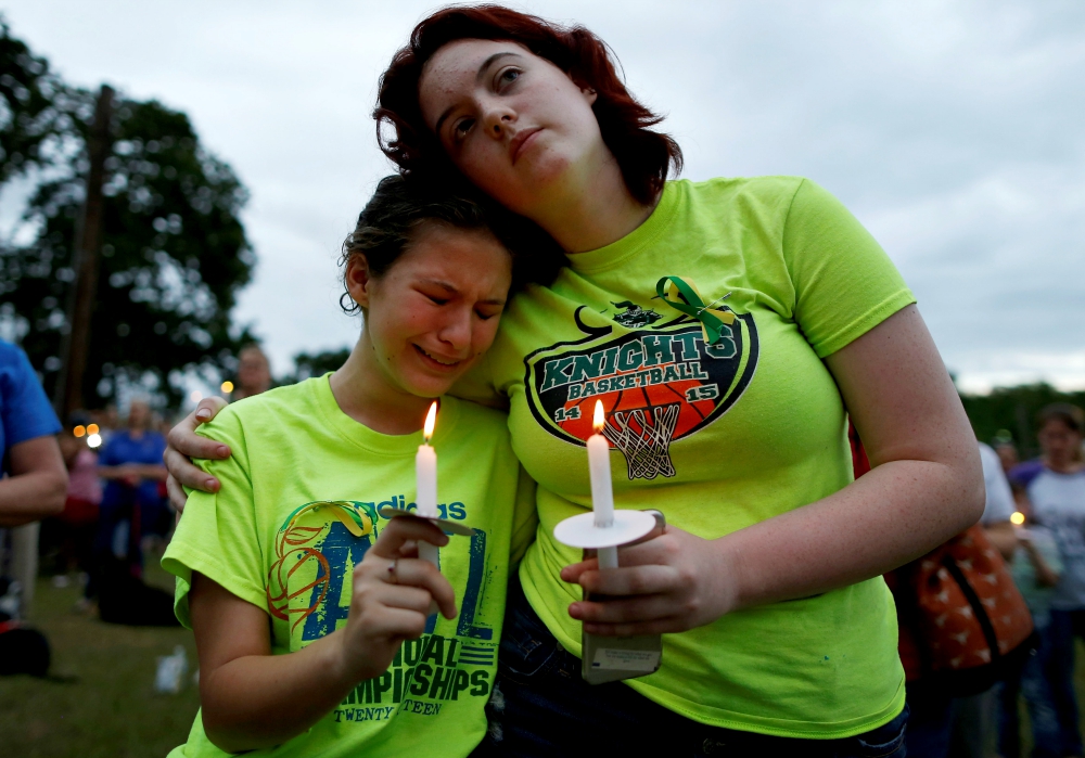 A young woman weeps during a vigil in memory of the victims killed in a shooting May 20 at Santa Fe High School in Texas. (CNS/Reuters/Jonathan Bachman) A young woman weeps during a vigil in memory of the victims killed in a shooting May 20 at Santa Fe High School in Texas. (CNS/Reuters/Jonathan Bachman)