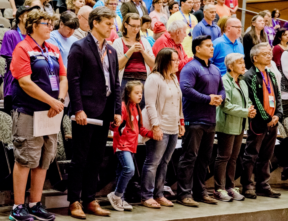 Tim Shriver, second from left, holds hands with Frannie Ronan, 9, during a June 30 Mass on the campus of the University of Washington in Seattle for athletes at the Special Olympics. (CNS/Courtesy of Seattle Archdiocese/Katie Niemar Photography) Tim Shriver, second from left, holds hands with Frannie Ronan, 9, during a June 30 Mass on the campus of the University of Washington in Seattle for athletes at the Special Olympics. (CNS/Courtesy of Seattle Archdiocese/Katie Niemar Photography)