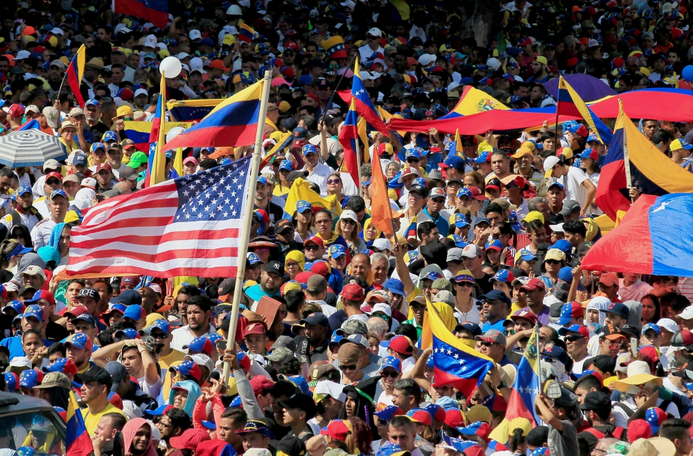 A U.S. flag waves in the crowd as protesters take part in a rally against Venezuelan President Nicolás Maduro's government in Maracaibo Jan. 23. (CNS/Reuters/Isaac Urrutia) A U.S. flag waves in the crowd as protesters take part in a rally against Venezuelan President Nicolás Maduro's government in Maracaibo Jan. 23. (CNS/Reuters/Isaac Urrutia)