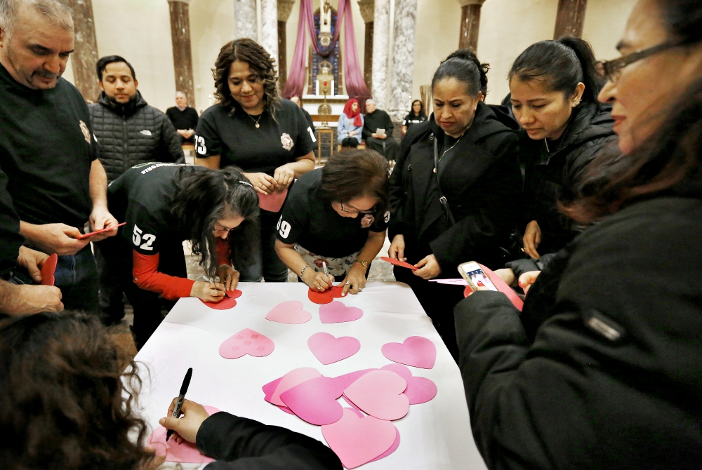 New citizens write their names on hearts to be displayed on the outside of St. Rita of Cascia Church in Bedford Park, Illinois, during a Pastoral Migratoria program March 30. (CNS/Chicago Catholic/Karen Callaway) New citizens write their names on hearts to be displayed on the outside of St. Rita of Cascia Church in Bedford Park, Illinois, during a Pastoral Migratoria program March 30. (CNS/Chicago Catholic/Karen Callaway)
