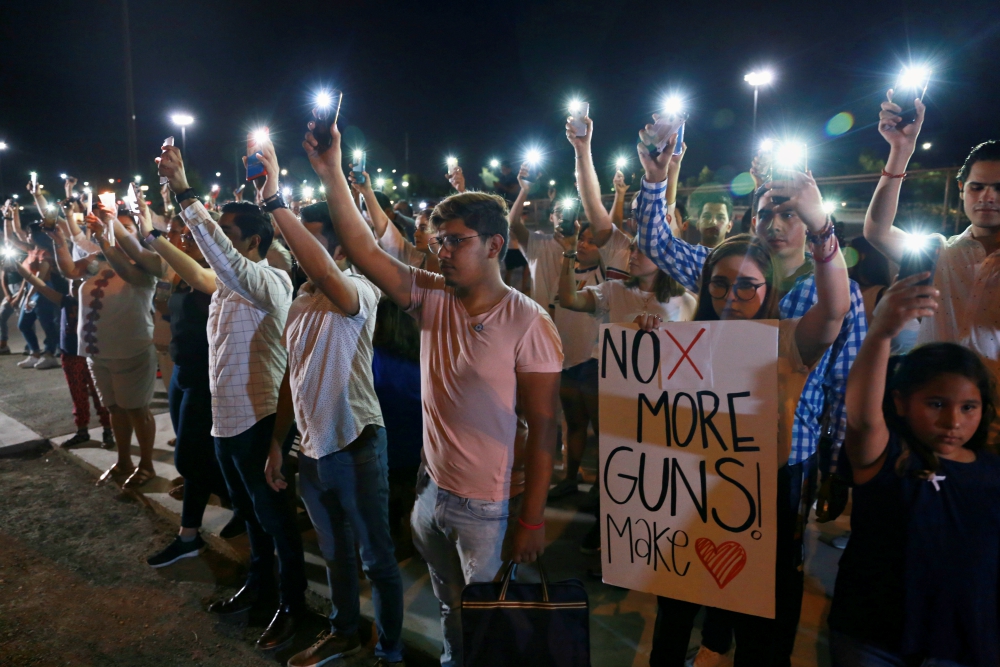 Mourners take part in a vigil near the border fence between Mexico and the U.S. after a mass shooting at a Walmart store in El Paso, Texas, Aug. 3. (CNS/Reuters/Carlos Sanchez) Mourners take part in a vigil near the border fence between Mexico and the U.S. after a mass shooting at a Walmart store in El Paso, Texas, Aug. 3. (CNS/Reuters/Carlos Sanchez)