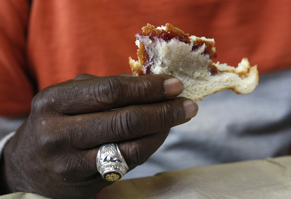 A man eats a sandwich at a soup kitchen in this 2016 file photo. (CNS/Karen Pulfer Focht) A man eats a sandwich at a soup kitchen in this 2016 file photo. (CNS/Karen Pulfer Focht)