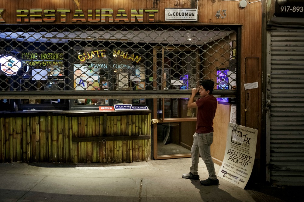 An employee closes the gate of a Latino restaurant in New York City April 2 during the coronavirus pandemic. (CNS/Reuters/Anna Watts) An employee closes the gate of a Latino restaurant in New York City April 2 during the coronavirus pandemic. (CNS/Reuters/Anna Watts)
