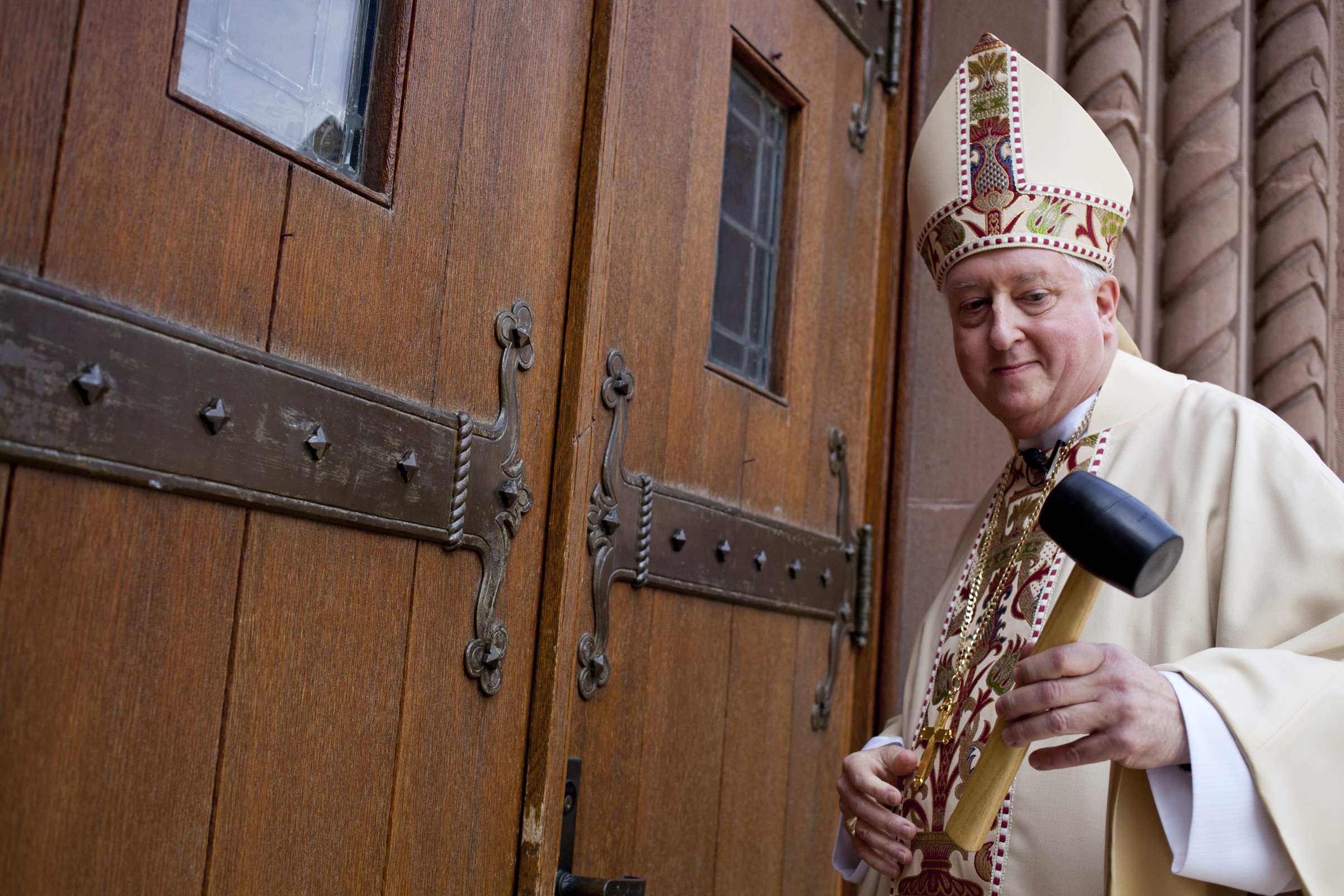 Bishop Mitchell Rozanski uses a mallet to knock three times on the doors of St. Michael's Cathedral in Springfield, Massachusetts, Aug. 12, 2014, before his installation as bishop of the diocese. (CNS/Catholic Review/Tom McCarthy Jr.) Bishop Mitchell Rozanski uses a mallet to knock three times on the doors of St. Michael's Cathedral in Springfield, Massachusetts, Aug. 12, 2014, before his installation as bishop of the diocese. (CNS/Catholic Review/Tom McCarthy Jr.)