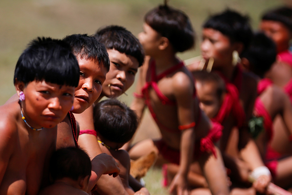 Young Yanomami look on as members of a medical team with the Brazilian army examine members of the Indigenous tribe in the state of Roraima July 1, 2020, during the COVID-19 pandemic. (CNS/Reuters/Adriano Machado) Young Yanomami look on as members of a medical team with the Brazilian army examine members of the Indigenous tribe in the state of Roraima July 1, 2020, during the COVID-19 pandemic. (CNS/Reuters/Adriano Machado)
