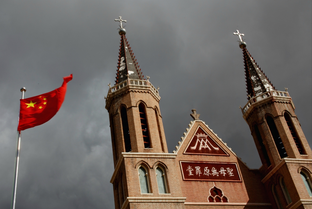 The Chinese national flag flies in front of a Catholic church in Huangtugang, China, in 2018. (CNS/Reuters/Thomas Peter) The Chinese national flag flies in front of a Catholic church in Huangtugang, China, in 2018. (CNS/Reuters/Thomas Peter)