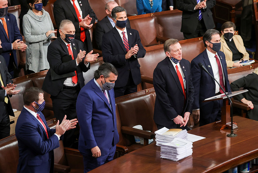 Rep. Paul Gosar, R-Ariz., right, and Sen. Ted Cruz, R-Texas, receive applause from Republicans inside the House Chamber on Capitol Hill Jan. 6 in Washington, for objecting to Arizona's votes during a joint session to certify the 2020 presidential election Rep. Paul Gosar, R-Ariz., right, and Sen. Ted Cruz, R-Texas, receive applause from Republicans inside the House Chamber on Capitol Hill Jan. 6 in Washington, for objecting to Arizona's votes during a joint session to certify the 2020 presidential election
