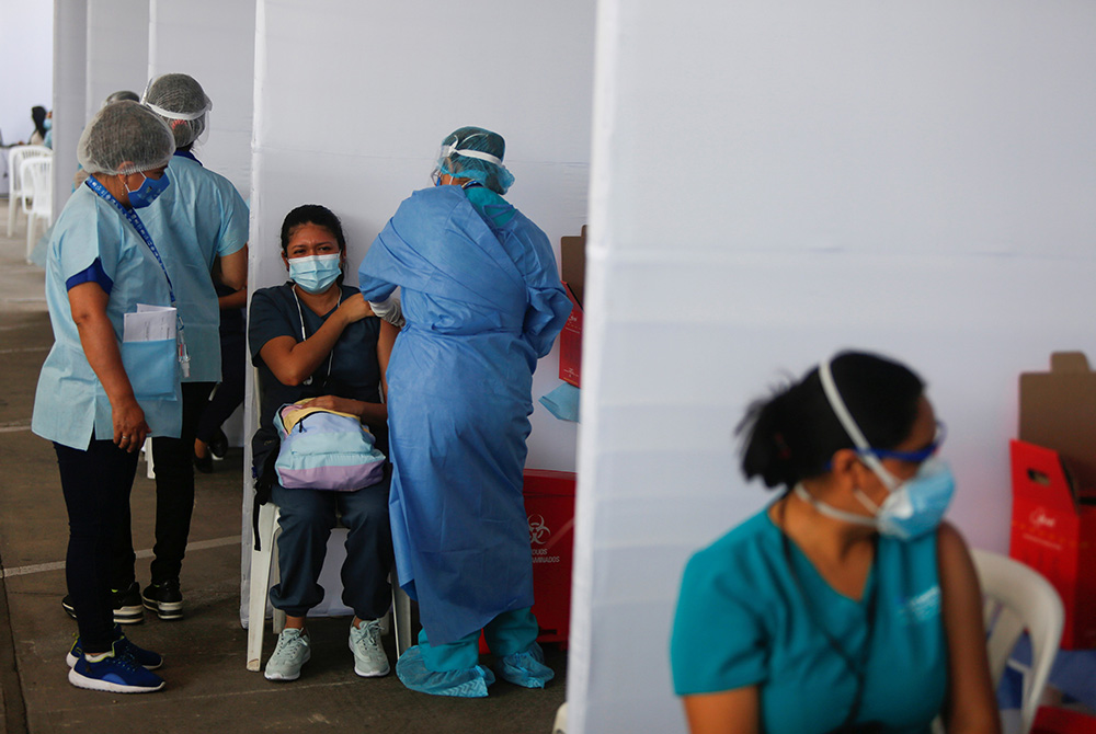 A health care worker receives a dose of Sinopharm's COVID-19 vaccine Feb. 9 in Lima, Peru. Peru's bishops denounced the giving of vaccines to VIPs instead of essential workers soon after the vaccine became available. One of those who received the vaccine A health care worker receives a dose of Sinopharm's COVID-19 vaccine Feb. 9 in Lima, Peru. Peru's bishops denounced the giving of vaccines to VIPs instead of essential workers after the vaccine became available. (CNS/Reuters/Sebastian Castaneda)