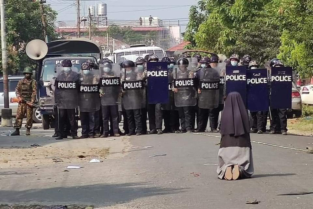 St. Francis Xavier Sr. Ann Nu Thawng kneels in front of police and soldiers during an anti-coup protest in Myitkyina, Myanmar, Feb. 28. (CNS/Courtesy of Myitkyina News Journal) St. Francis Xavier Sr. Ann Nu Thawng kneels in front of police and soldiers during an anti-coup protest in Myitkyina, Myanmar, Feb. 28, 2021.