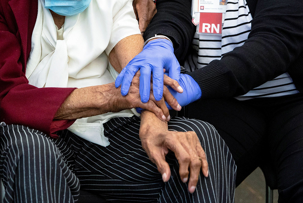 A 111-year-old woman is comforted by a nurse following her COVID-19 vaccination at IU Health Neuroscience Center March 16 in Indianapolis. (CNS/Chris Bergin, Reuters) A 111-year-old woman is comforted by a nurse following her COVID-19 vaccination at IU Health Neuroscience Center March 16 in Indianapolis. (CNS/Chris Bergin, Reuters)