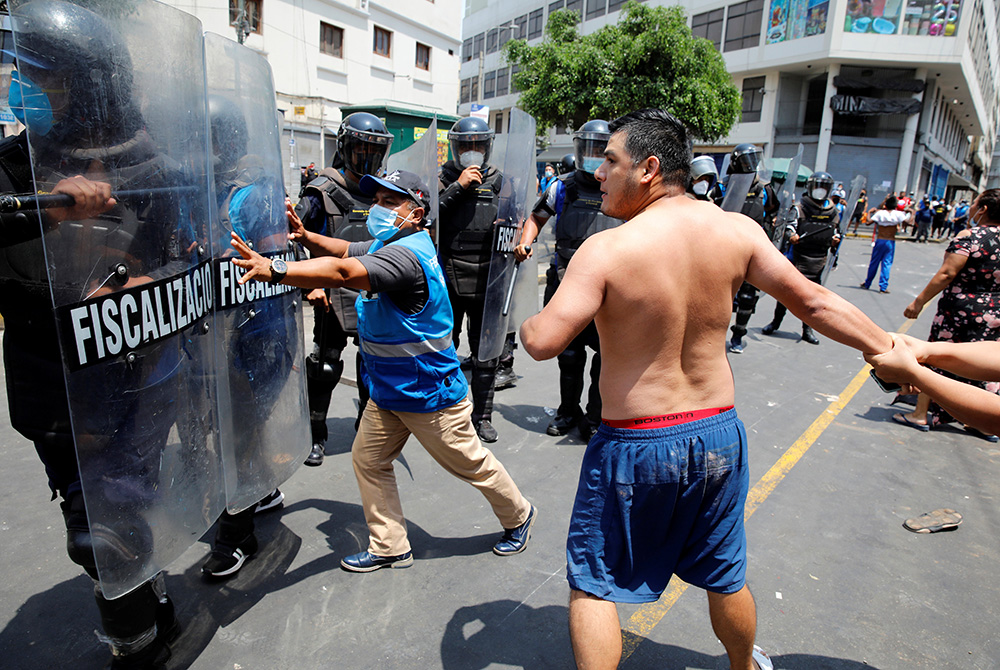 Protesters and street vendors argue with riot police over new government restrictions Feb. 1 in Lima, Peru. (CNS/Reuters/Sebastian Castaneda) Protesters and street vendors argue with riot police over new government restrictions Feb. 1 in Lima, Peru. (CNS/Reuters/Sebastian Castaneda)