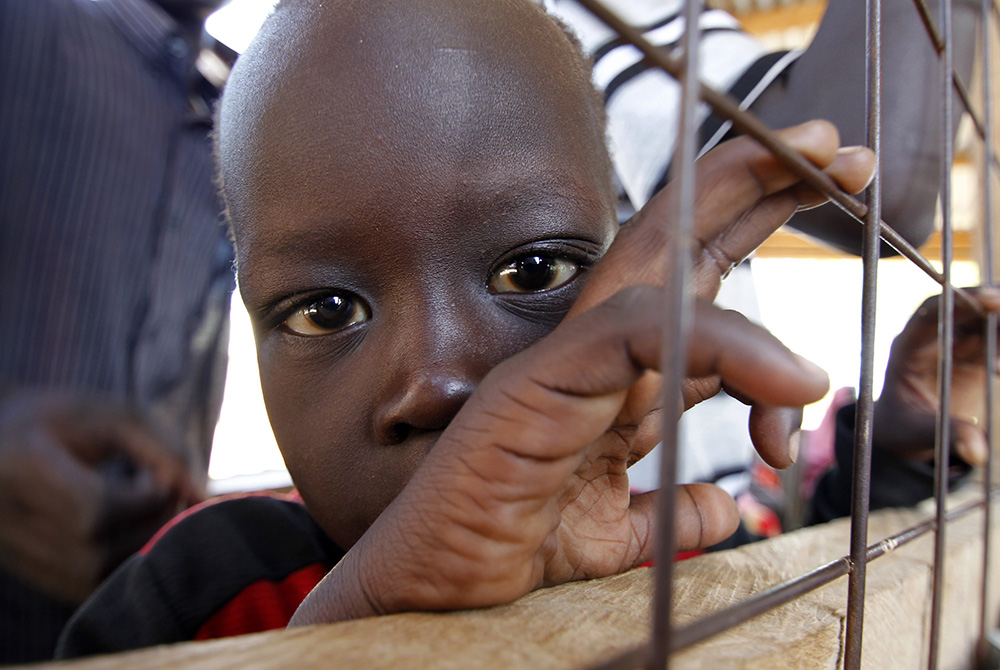 A child from South Sudan is pictured in a 2012 photo at a registration center in the Kakuma refugee camp in northern Kenya. Catholic bishops in Kenya are urging the government to shelve plans to close two refugee camps that host refugees who fled civil wa A child from South Sudan is pictured in a 2012 photo at a registration center in the Kakuma refugee camp in northern Kenya. Catholic bishops in Kenya are urging the government to shelve plans to close two refugee camps that host refugees who fled civil wa