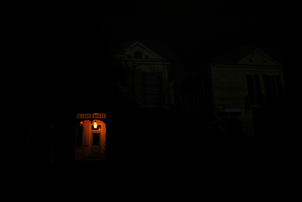 A front porch in New Orleans lit by a flame A front porch in New Orleans is lit by a flame on a dark street Aug. 31 in the midst of a power outage caused by Hurricane Ida. (CNS/Reuters/Leah Millis)