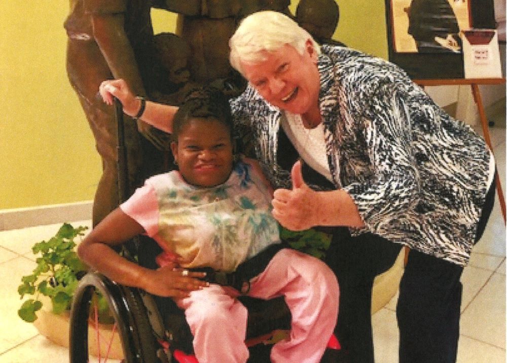 Sr. of Charity Nuala Patricia Kenny poses with a patient.