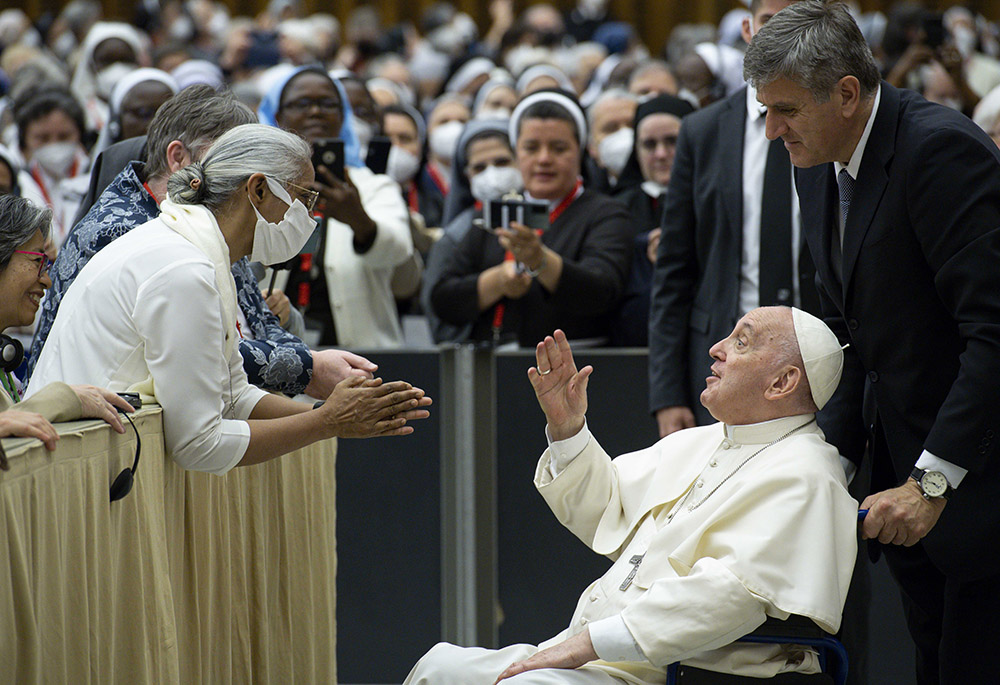 Pope Francis is pushed in a wheelchair by his aide, Sandro Mariotti, as he greets participants May 5 in the plenary assembly of the women's International Union of Superiors General at the Vatican. (CNS/Vatican Media) Pope Francis is pushed in a wheelchair by his aide, Sandro Mariotti, as he greets participants May 5 in the plenary assembly of the women's International Union of Superiors General at the Vatican. (CNS/Vatican Media)