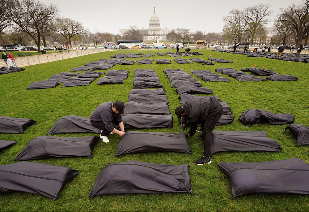 Body bags are placed on the National Mall in Washington near the U.S. Capitol on March 24. (CNS/Reuters/Kevin Lamarque) Body bags are placed on the National Mall in Washington near the U.S. Capitol on March 24. (CNS/Reuters/Kevin Lamarque)