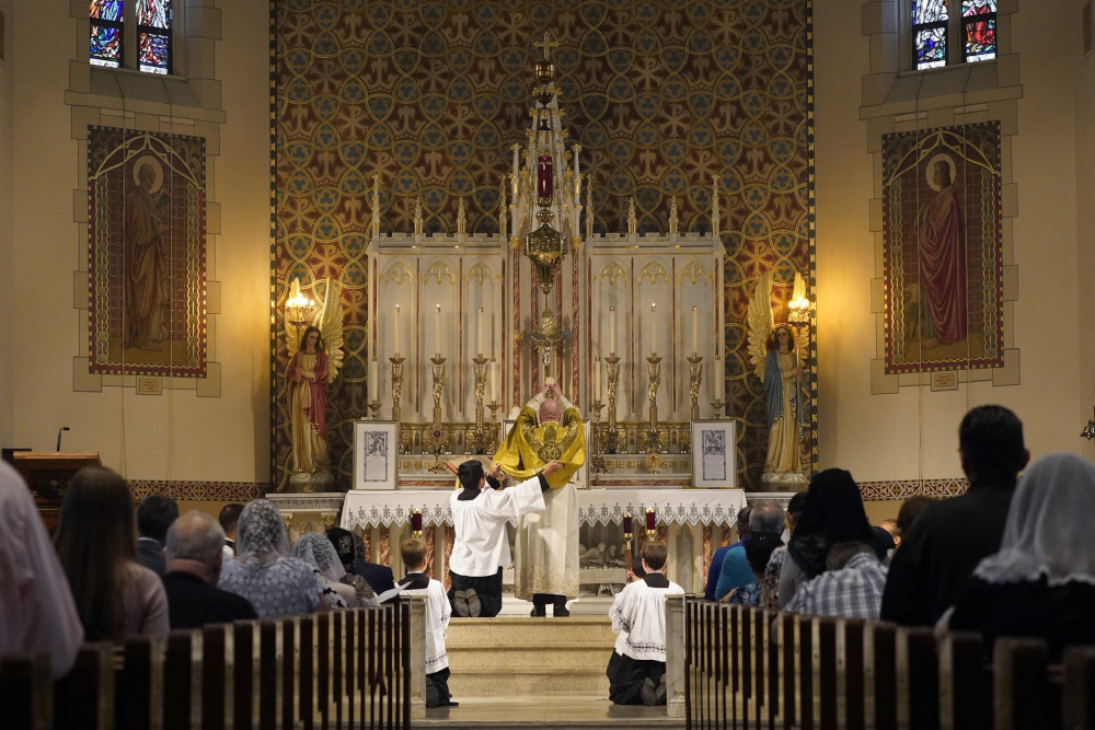 A priest elevates the Eucharist during a traditional Tridentine-rite Mass in July 2021 at St. Josaphat Church in the Queens borough of New York City. (CNS photo/Gregory A. Shemitz)