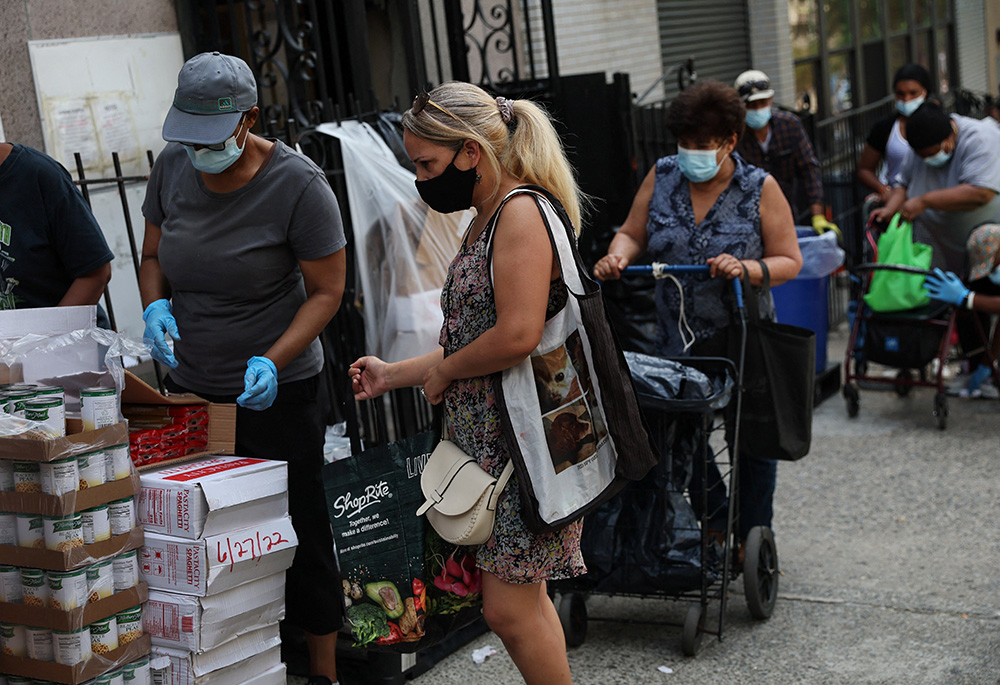 People receive food donations July 13 from a food pantry outside a church in the Bronx borough of New York City. (CNS/Reuters/Shannon Stapleton) People receive food donations July 13 from a food pantry outside a church in the Bronx borough of New York City. (CNS/Reuters/Shannon Stapleton)