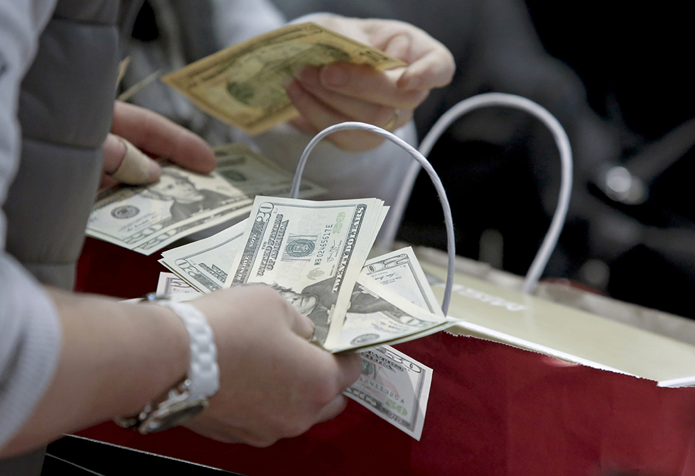 People count money in this undated photo. (CNS/Reuters/Andrew Kelly) People count money in this undated photo. (CNS/Reuters/Andrew Kelly)