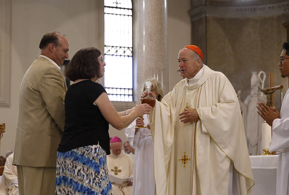 New Cardinal Robert McElroy of San Diego accepts offertory gifts from his sister, Kathy Schreiner, and brother, Walter McElroy, as he celebrates a Mass of thanksgiving at St. Patrick's Church Aug. 28 in Rome. (CNS photo/Paul Haring) New Cardinal Robert McElroy of San Diego accepts offertory gifts from his sister, Kathy Schreiner, and brother, Walter McElroy, as he celebrates a Mass of thanksgiving at St. Patrick's Church Aug. 28 in Rome. (CNS photo/Paul Haring)