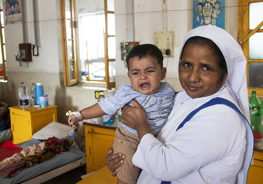 Sister Mary Dipali tries to calm an ill child in Kumudini Hospital in Mirzapur, Bangladesh, around 60 kilometers from Dhaka. (Uttom S. Rozario)