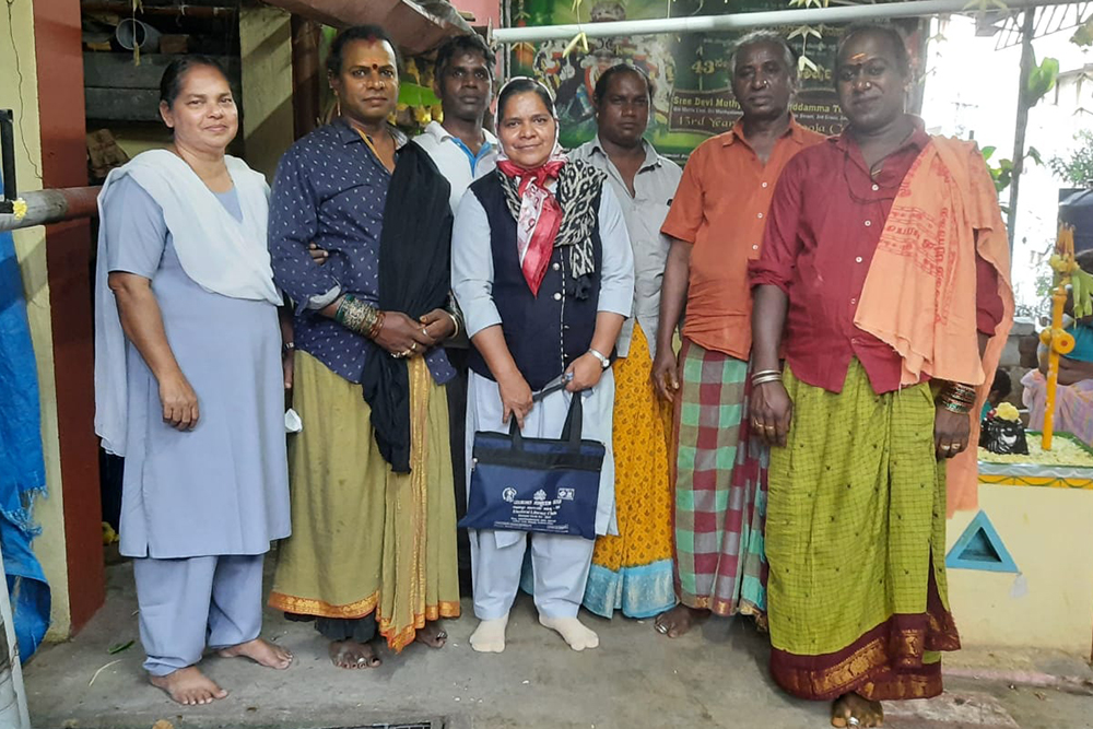 : Fatima Sr. Roseline Jose, left, and Sr. Saly Joseph, center, members of the Sisters of Our Lady of Fatima of Pune, pose with a group of older members of the transgender community in Bengaluru, India.