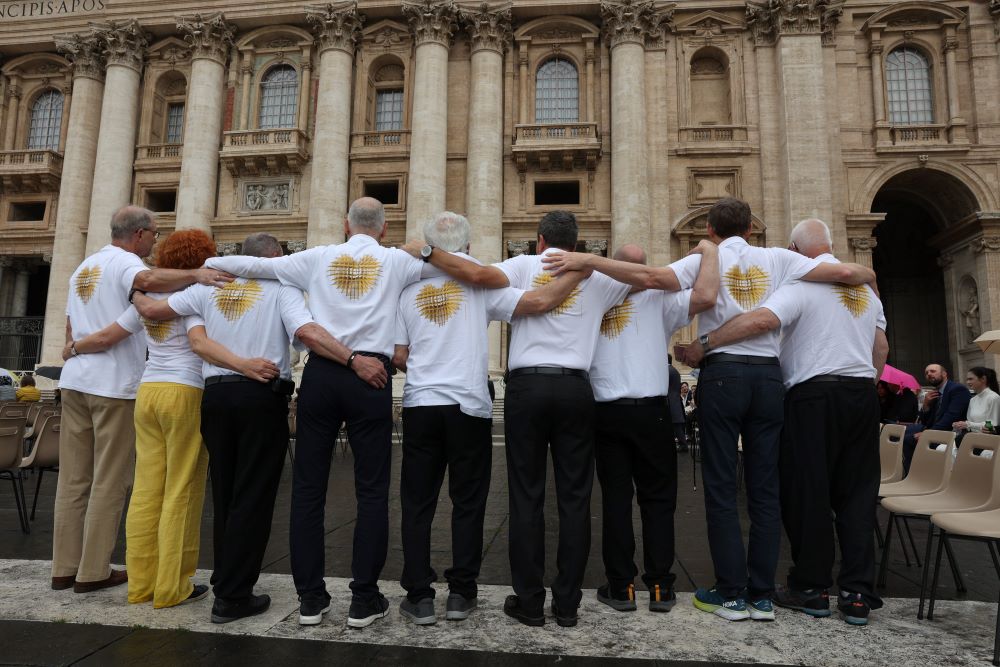 Eight men and one woman stand facing St. Peter's Basilica at the end of Pope Francis' weekly general audience in St. Peter's Square at the Vatican May 17.