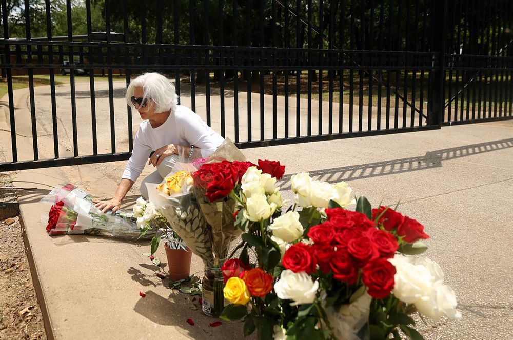 Janice Vonada de Keller, Texas, coloca rosas en la puerta del Monasterio de la Santísima Trinidad de las Carmelitas Descalzas de Arlington en Arlington, Texas, el 31 de mayo.