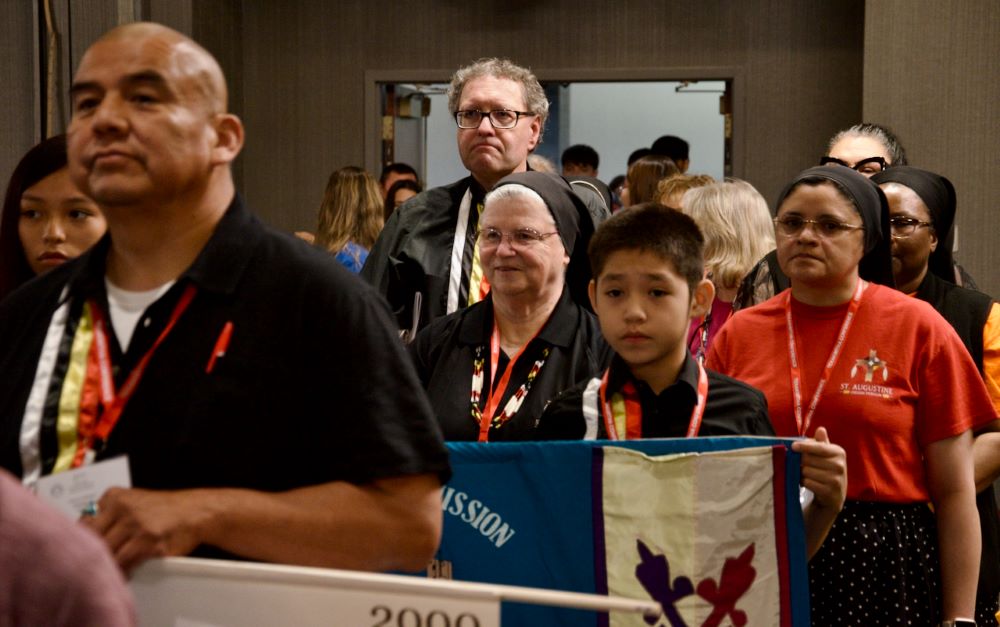 Sr. Deana Case, of the Missionary Benedictine Sisters of Norfolk, Nebraska, takes part in the Grand Entry at the Tekakwitha Conference July 20 in Minneapolis, Minnesota. (GSR photo/Dan Stockman)