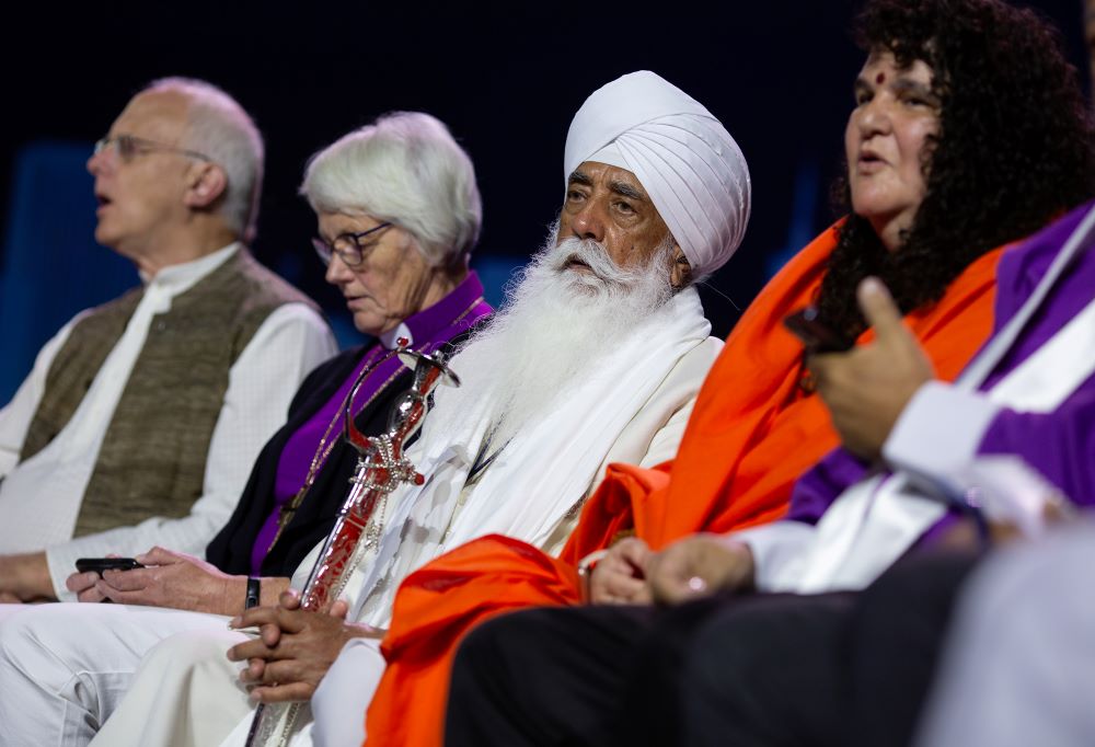 Bhai Mohinder Singh, center, and other religious leaders chant on stage during a climate repentance ceremony at the Parliament of the World’s Religions in Chicago on Aug. 15, 2023.