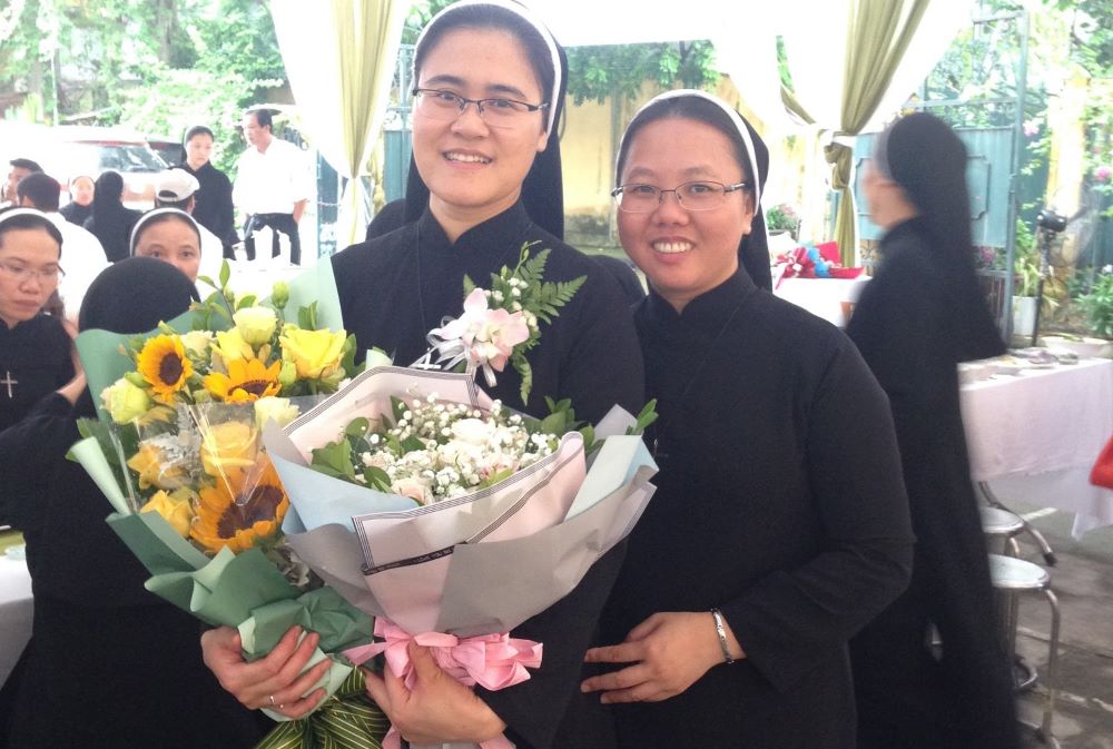 Sr. Ngoc Nguyen made her perpetual vows with the Congregation of the Lovers of the Holy Cross in Vietnam at St. Joseph Cathedral in the Diocese of Hanoi on Aug. 1, 2019. At right is Sr. Yen Le. (Courtesy of Ngoc Nguyen)