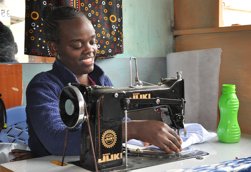 Lynn Chepng'eny is pictured at her dressmaking business in Kariobangi North in Nairobi. Apart from dressmaking and tailoring skills, she says she benefited from counseling and character formation classes at the Kariobangi Women Promotion Training Institute. (Lourine Oluoch)