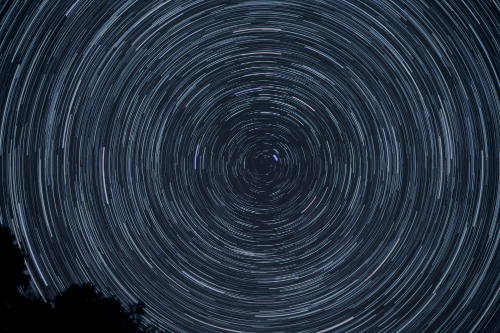 a series of circles inside each other against a dark background, evoking the cosmos