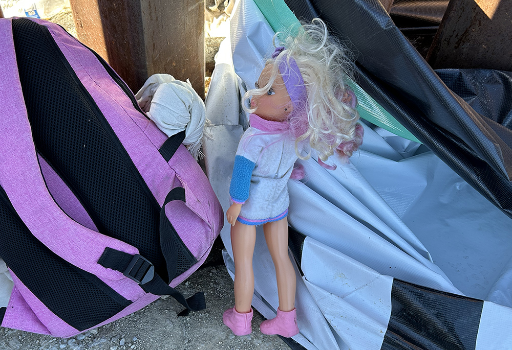 A doll is pictured, belonging to a child who had just entered the U.S. with her family through a gap in the border wall. The child, her sibling and their mother sat down on an empty milk crate. They set their few belongings aside, including the doll. (Peter Tran)
