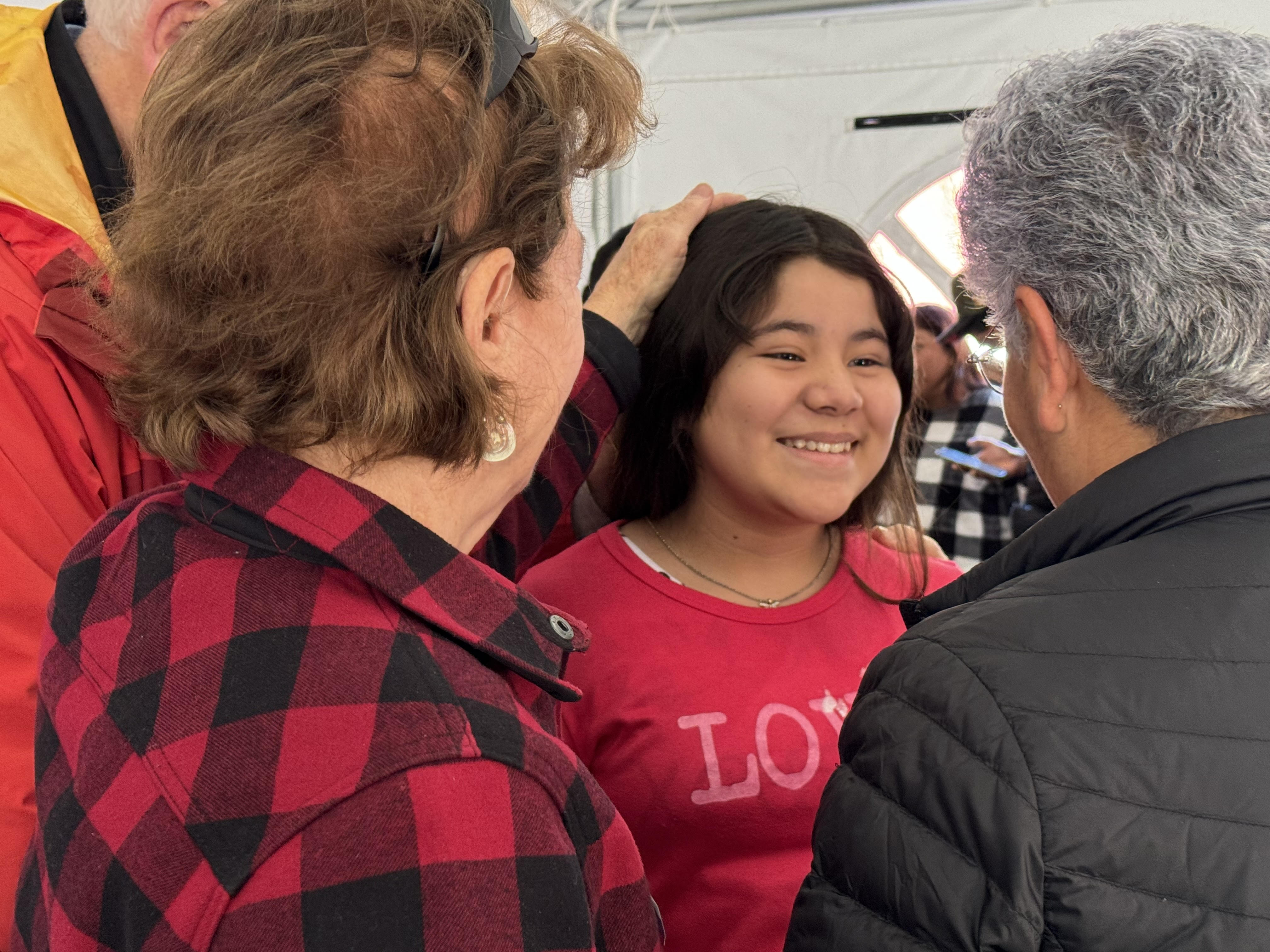 Sr. Carol Selak, of the Sisters of the Holy Name of Jesus and Mary, and Sr. Beatriz Tavera, of the Sisters of Social Service, speak with a teenager after she received a blessing Feb. 8 at the Cobina Posada del Migrante Shelter in Mexicali, Mexico. (GSR photo/Rhina Guidos)