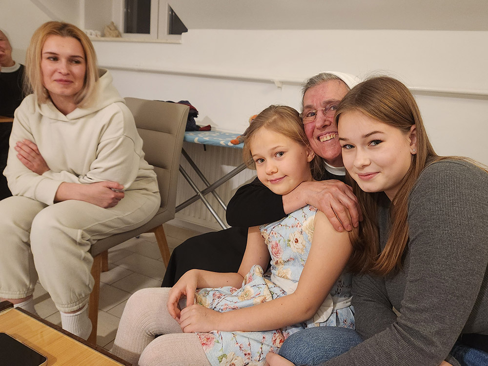 Sr. M. Franka Odrljin, center, a member of the Sisters of Charity of Zagreb in Croatia, with members of the Ouchynnikova family, who have settled in the coastal city of Split, living in a convent space provided by the sisters. Maria, 37, the mother, is at left with daughters 16-year-old Sofia, right, and 8-year-old Anastasia, center. Odrljin is the director of the sisters' Split refugee ministry.