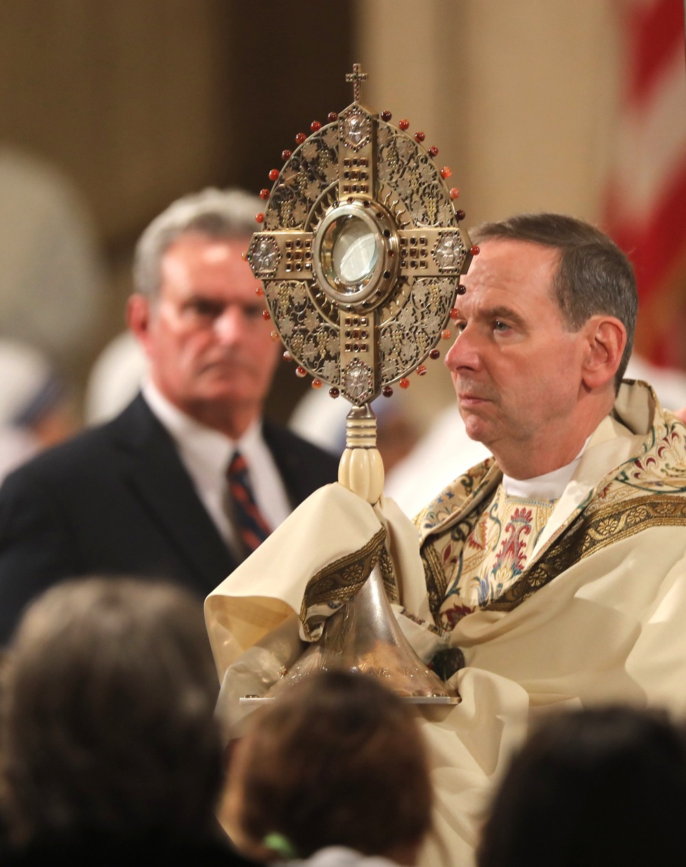 'Christian Nationalism' incompatible with Catholic Social Teaching. Bishop, vested, exposes Eucharistic Host in monstrance.