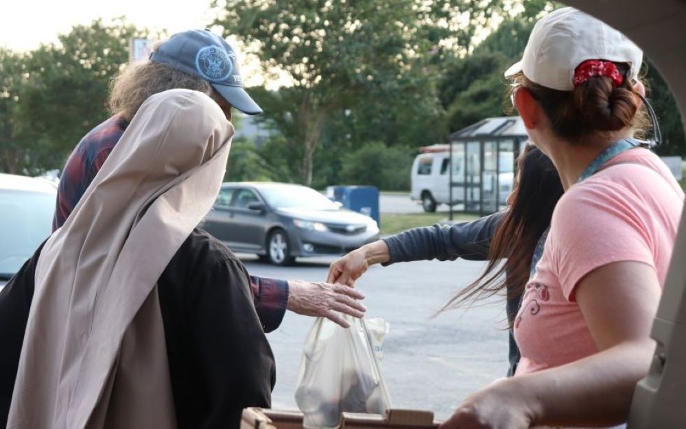 Community members accept food from members of the Sisters Poor of Jesus Christ in Cedartown, Georgia.
