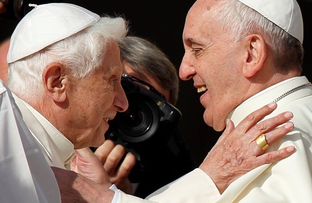 Pope Francis greets retired Pope Benedict XVI during an encounter for the elderly in St. Peter's Square at the Vatican Sept. 28, 2014.