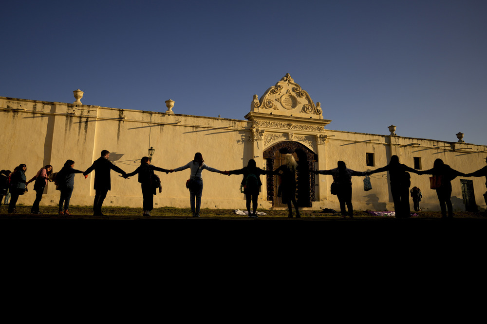 Argentina Nuns Gender Violence Women join hands to form a chain outside convent