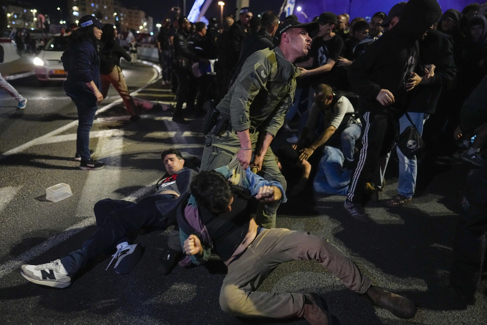 Jerusalem protest against Netanyahu. Police drag Israeli protesters through street in Jerusalem.