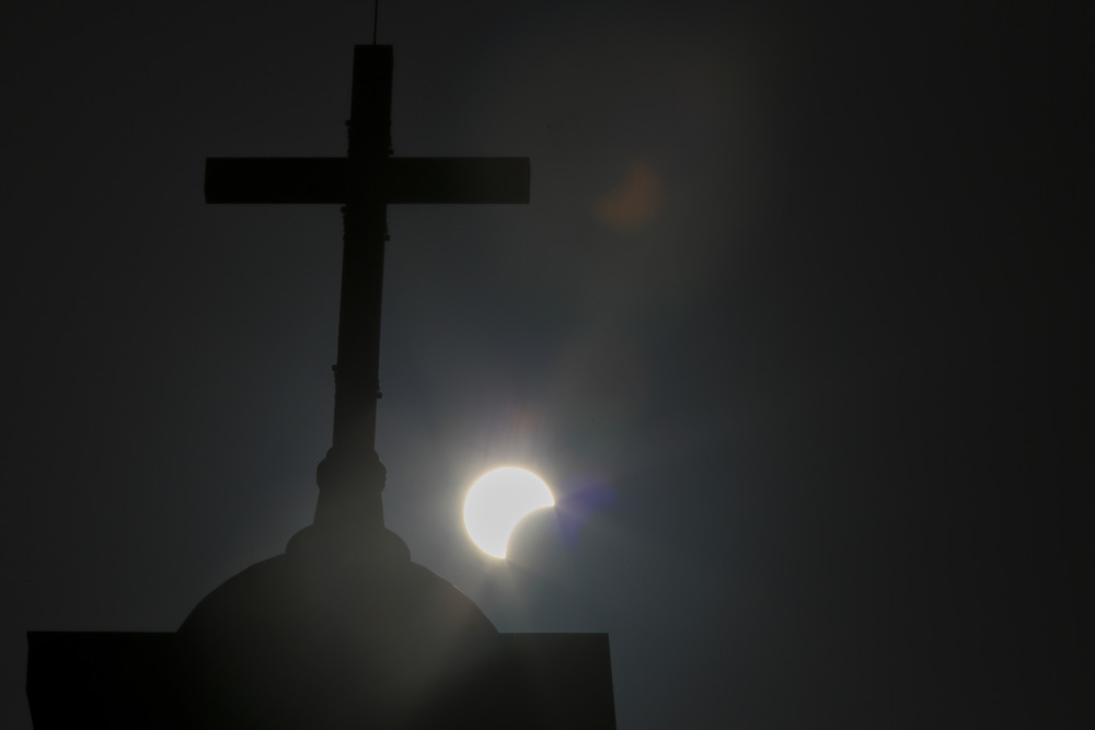 Total Solar Eclipse 2024 Cross silhouetted against eclipsing sun