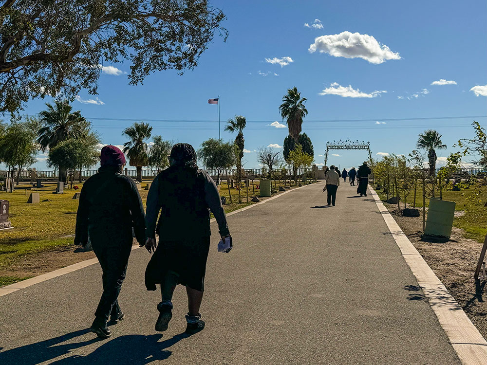 Sr. Mary Grace Ramos, left, and Sr. Florence Anyabuonwu, both Sisters of St. Joseph of Orange, California, walk out of Terrace Park Cemetery in Holtville, California, Feb. 7. They were part of a group of women religious who prayed near tombs fenced off from the rest of the cemetery that include remains of anonymous migrants who died nearby. (GSR photo/Rhina Guidos)